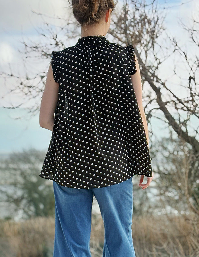 black and white polka dot chiffon sleeveless top with ruffle edged detail