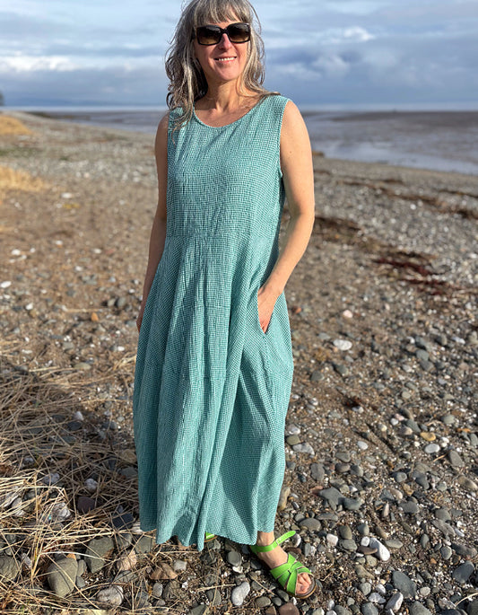 woman wearing maxi sleeveless bubble dress in teal mini check