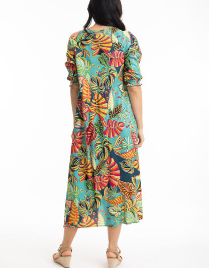 midi length swing shaped dress with elbow sleeve and v neckline in tropical print