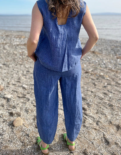 Person wearing a blue outfit standing on a beach
