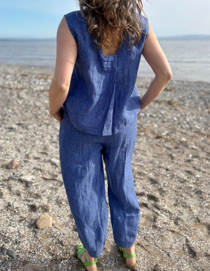 Person wearing a blue outfit standing on a beach
