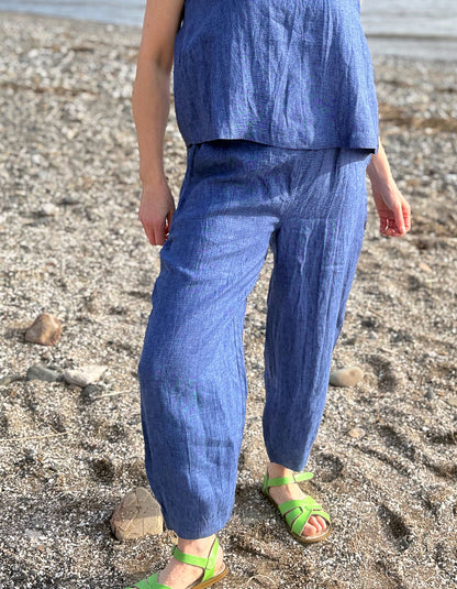 Person wearing a blue outfit standing on a beach