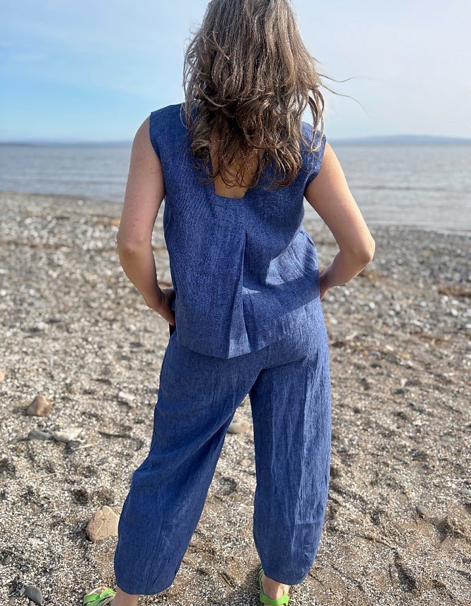 Person wearing a blue outfit standing on a beach