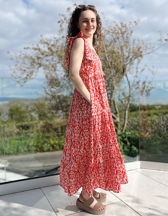 red and white hand block print cotton maxi dress with tie shoulder straps and a tiered skirt