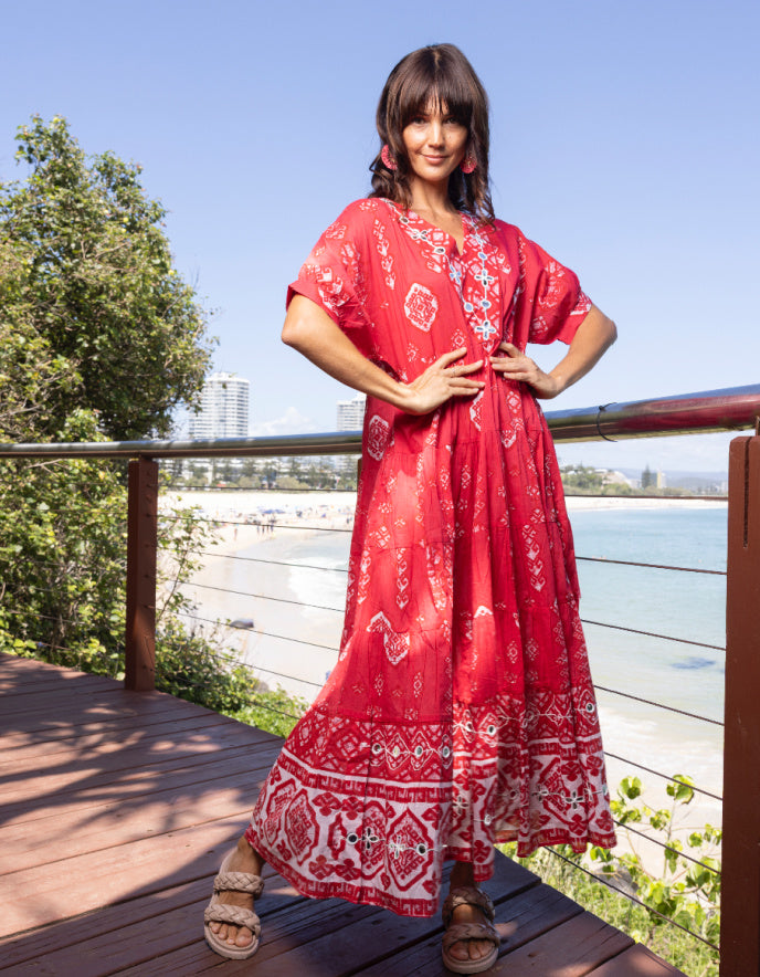 woman wearing red cotton boho dress with white patterns in Moroccan setting