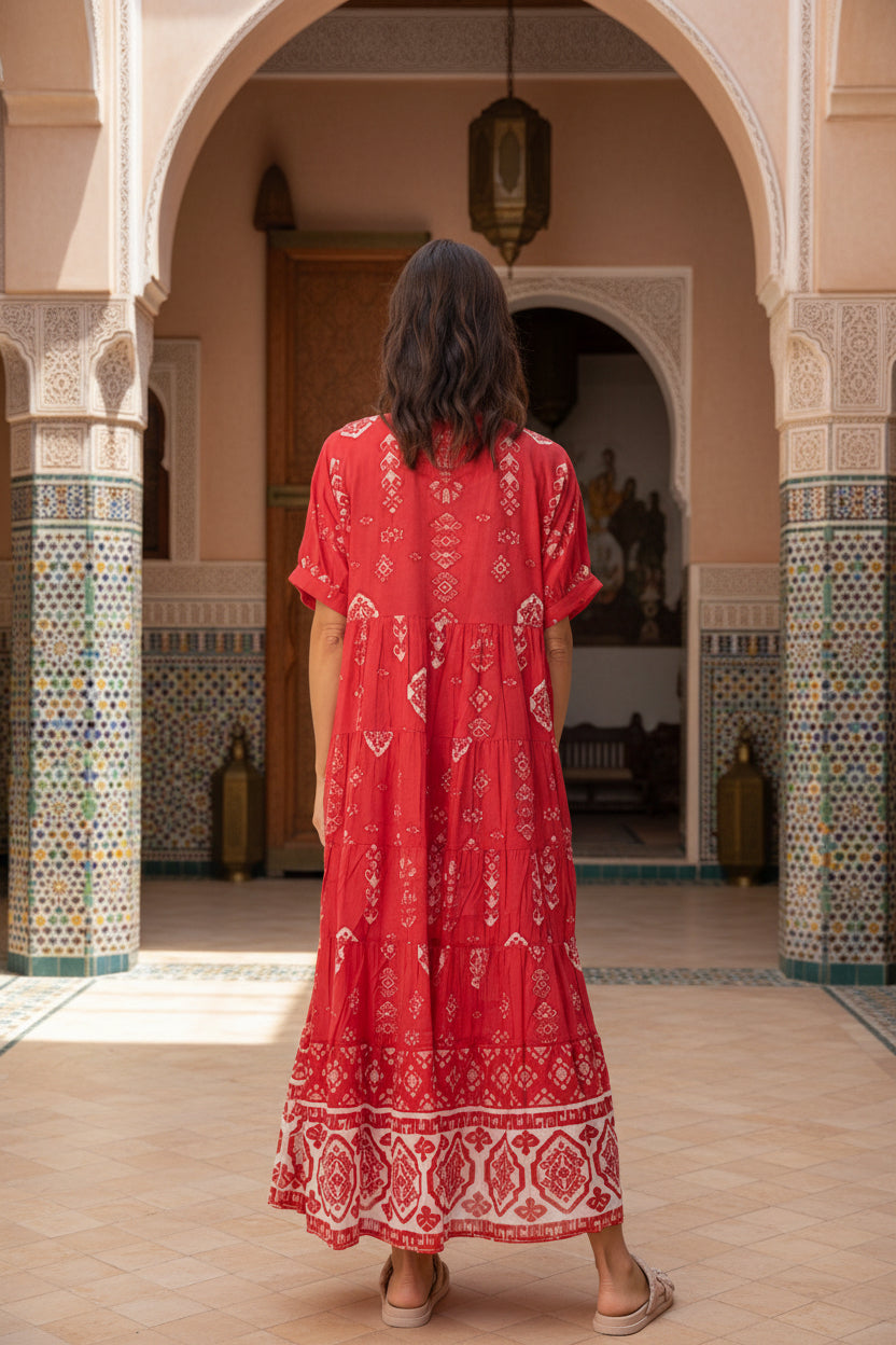 woman wearing red cotton boho dress with white patterns in Moroccan setting