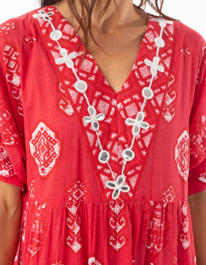 woman wearing red cotton boho dress with white patterns 