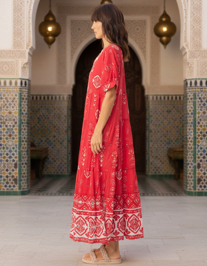 woman wearing red cotton boho dress with white patterns in Moroccan setting