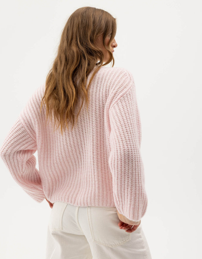 woman wearing pale pink ribbed knitted sweater