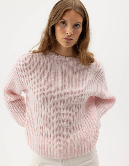 woman wearing pale pink ribbed knitted sweater