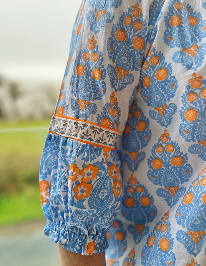 loose fit summer boho style top with wide ruffle sleeves, tassel ties in sky blue and neon orange