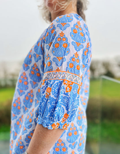 loose fit summer boho style top with wide ruffle sleeves, tassel ties in sky blue and neon orange