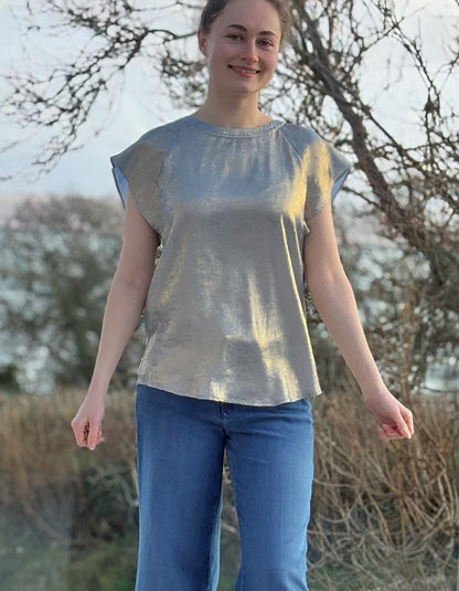 champagne coloured top with crew neck and fluted sleeves