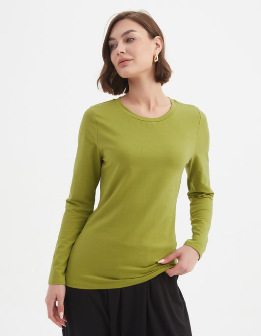 Woman wearing a green long-sleeve top on a white background