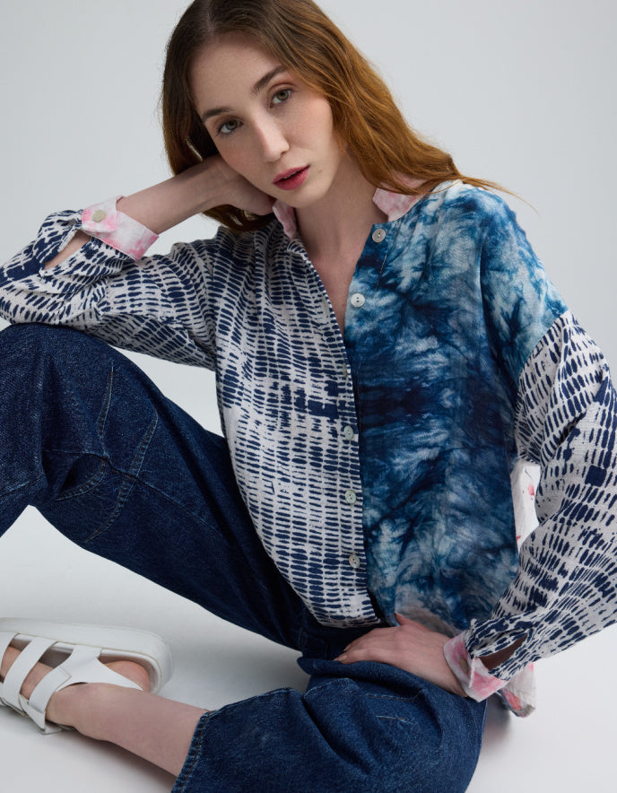 woman wearing blue cotton blouse with cherry blossom on the back