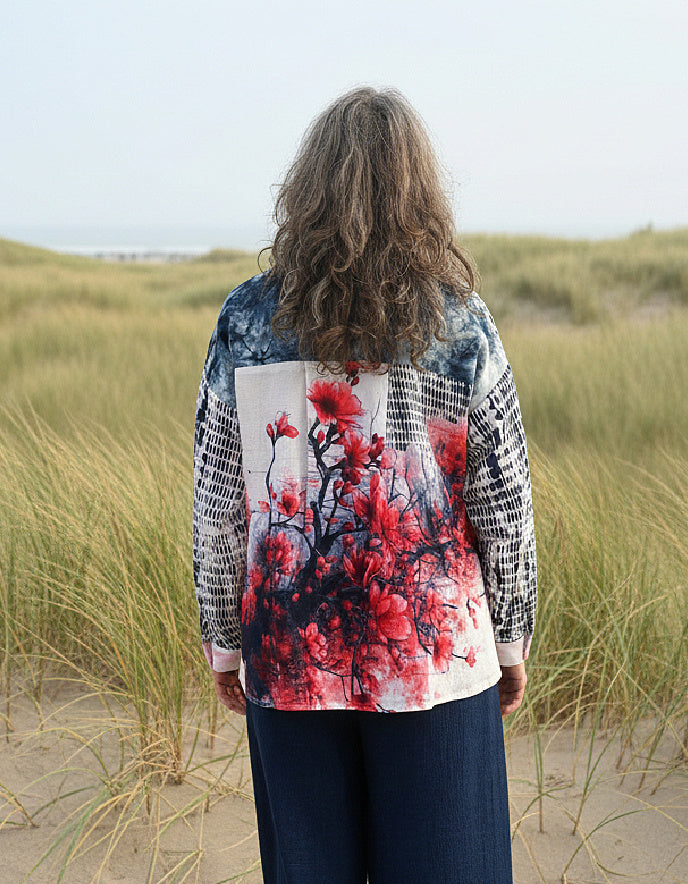 woman wearing blue cotton blouse with cherry blossom on the back