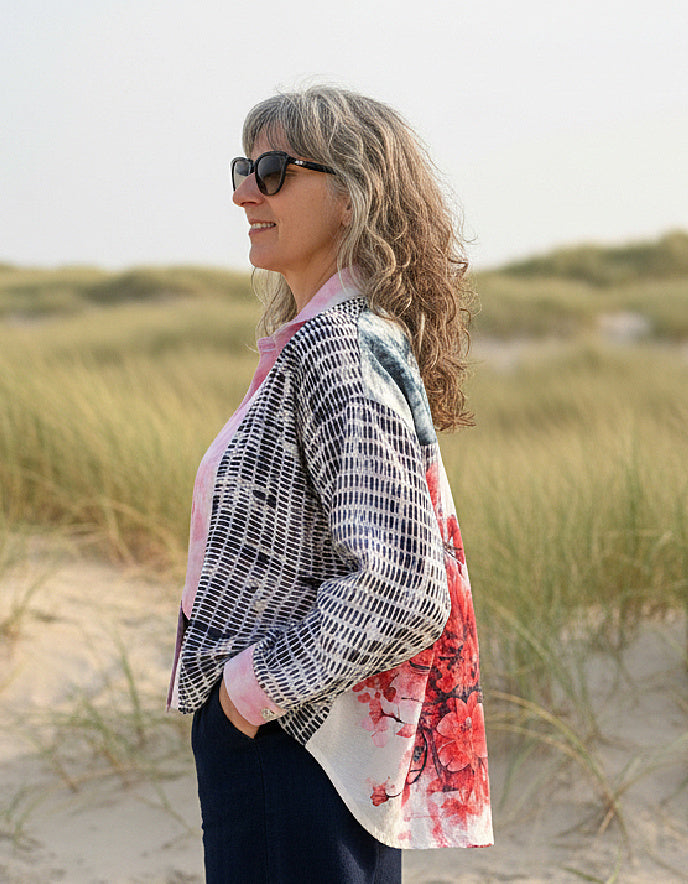 woman wearing blue cotton blouse with cherry blossom on the back