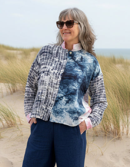woman wearing blue cotton blouse with cherry blossom on the back