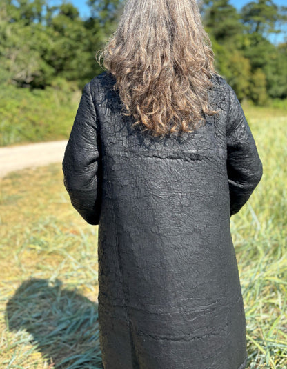 woman wearing black winter coat with distressed finish