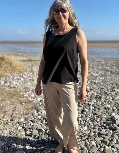 woman wearing black tank top on a beach