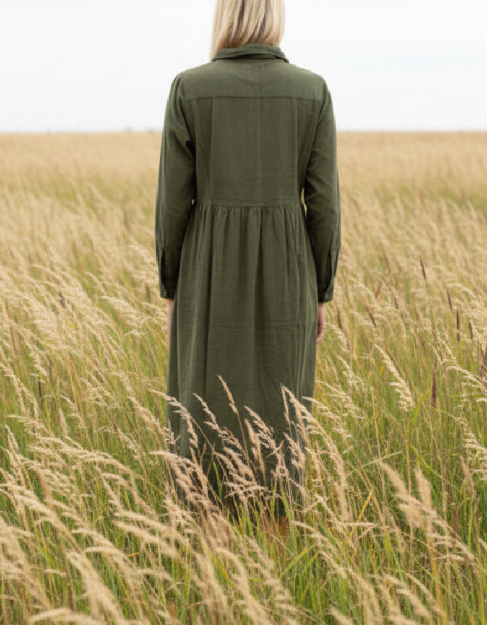 lady wearing olive green cord shirt dress in a field