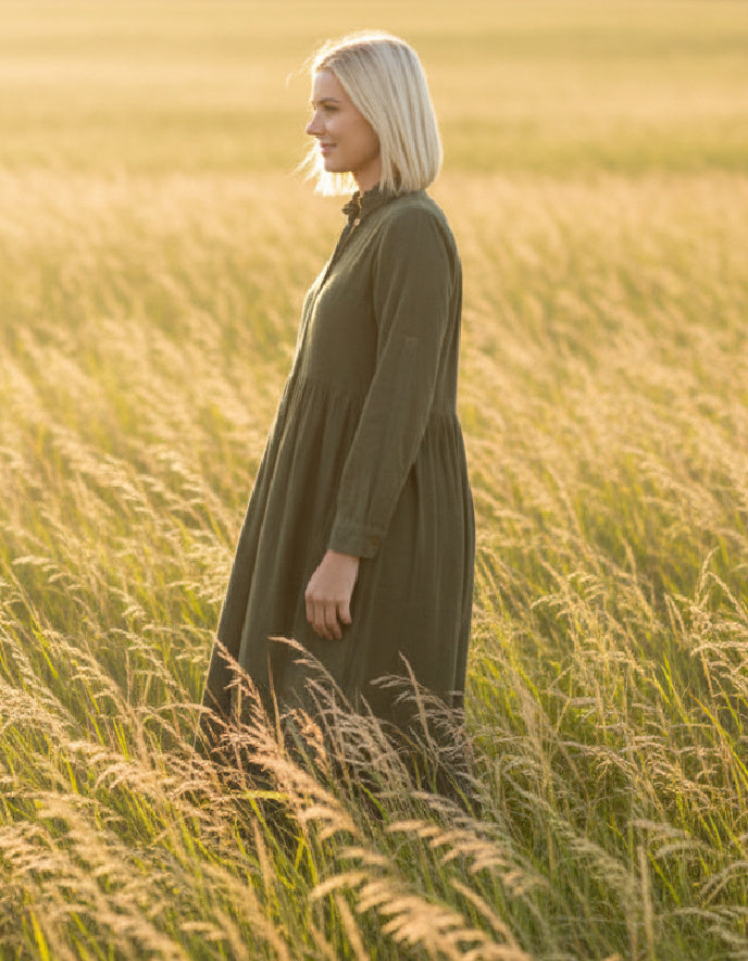 lady wearing olive green cord shirt dress in a field