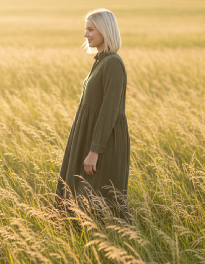 lady wearing olive green cord shirt dress in a field