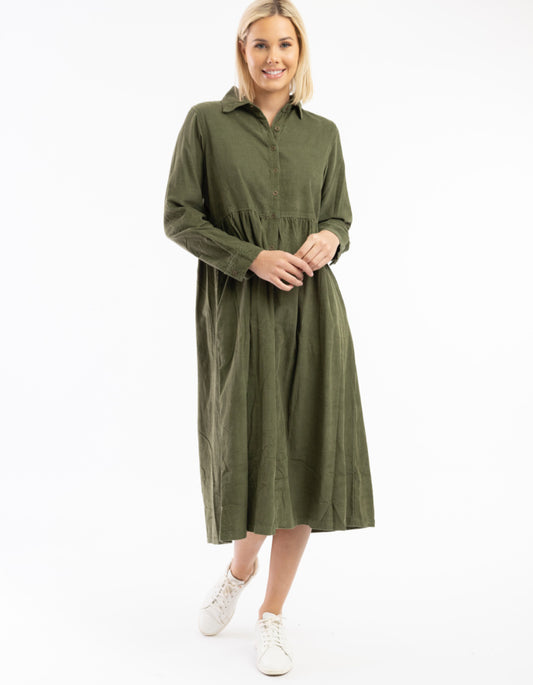 Woman wearing a green dress on a white background