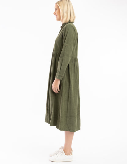 Woman wearing a green dress on a white background