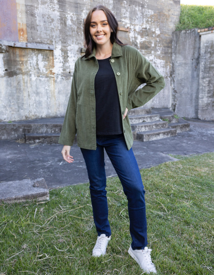 woman wearing olive green cord shirt stye jacket
