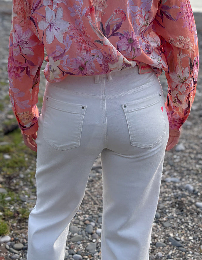 summer cropped cream jeans worn with a floral peach print cotton blouse