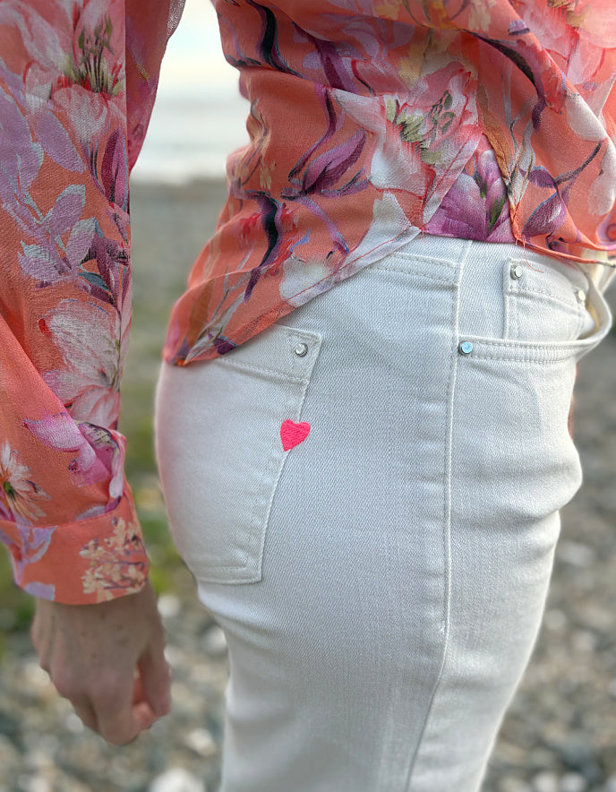 summer cropped cream jeans worn with a floral peach print cotton blouse