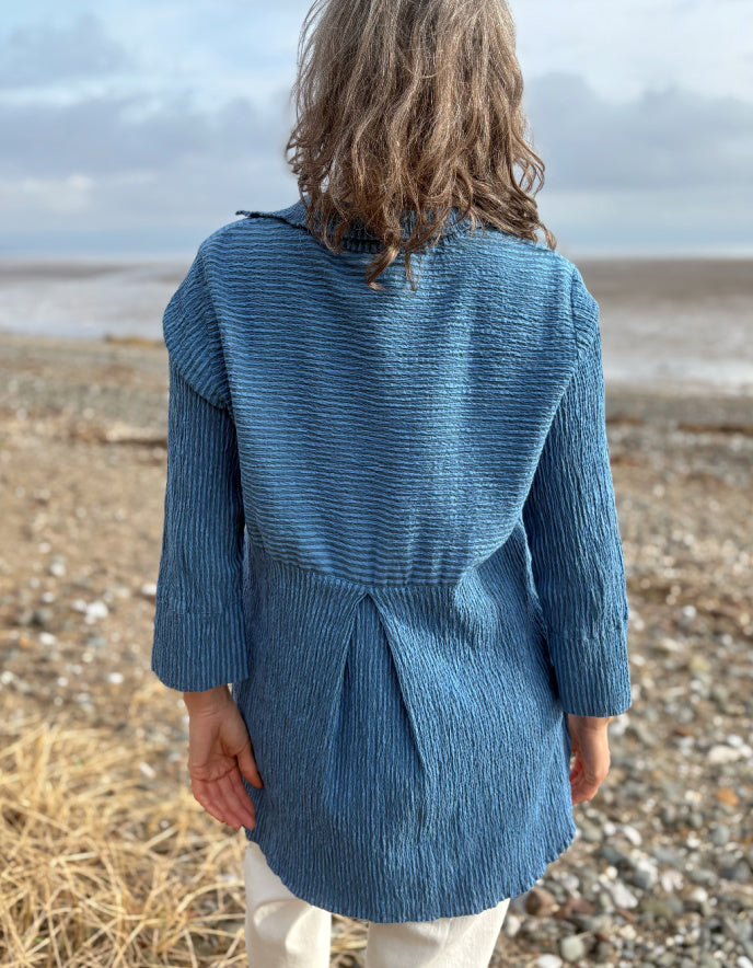 woman wearing blue striped loose fit shirt