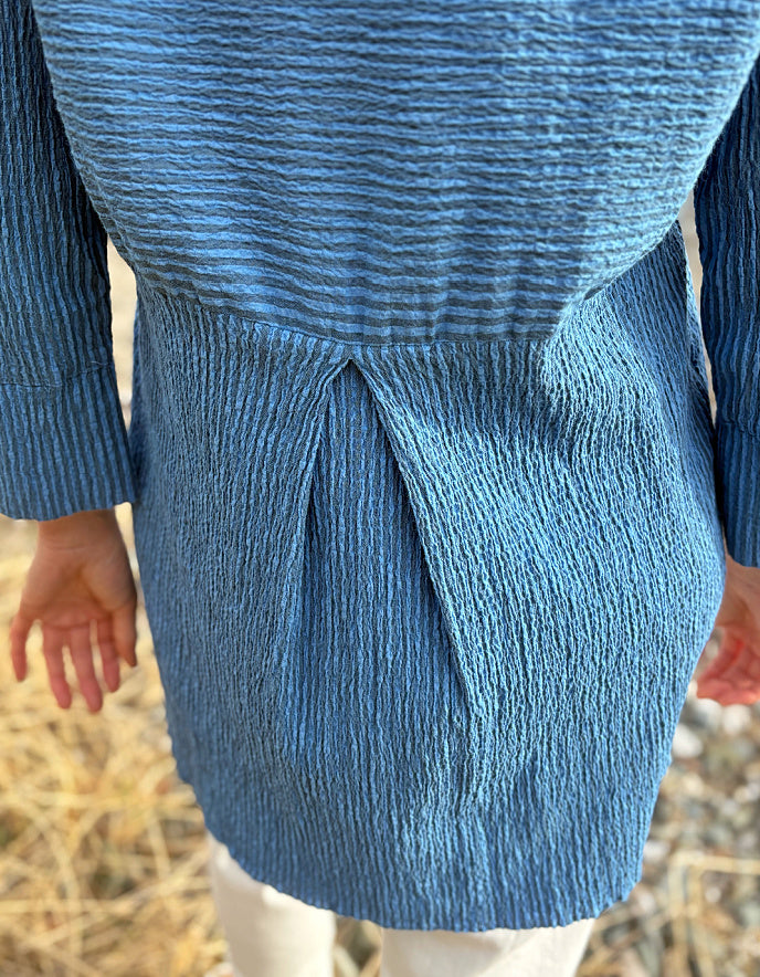 woman wearing blue striped loose fit shirt