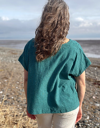 woman wearing boxy teal linen top with jeans