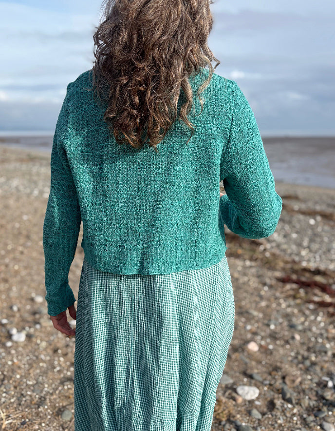 woman wearing cropped jumper over maxi bubble dress in teal