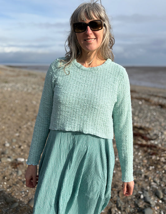curved cropped jumper in mint over a maxi bubble dress