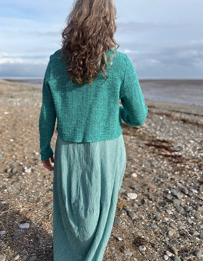 woman wearing cropped jumper over maxi bubble dress in teal