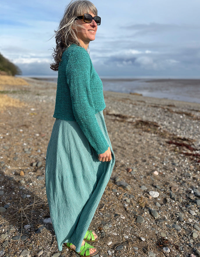 woman wearing maxi sleeveless bubble dress in teal mini check