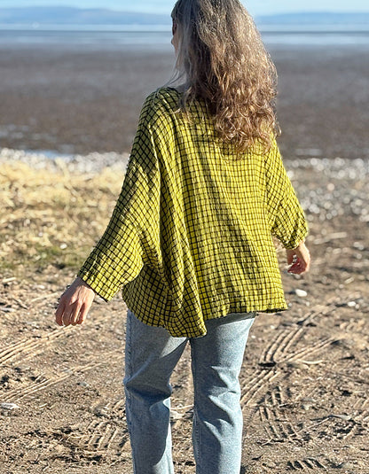 oversized one size top with drape. ochre shade of green with black check print, round neckline