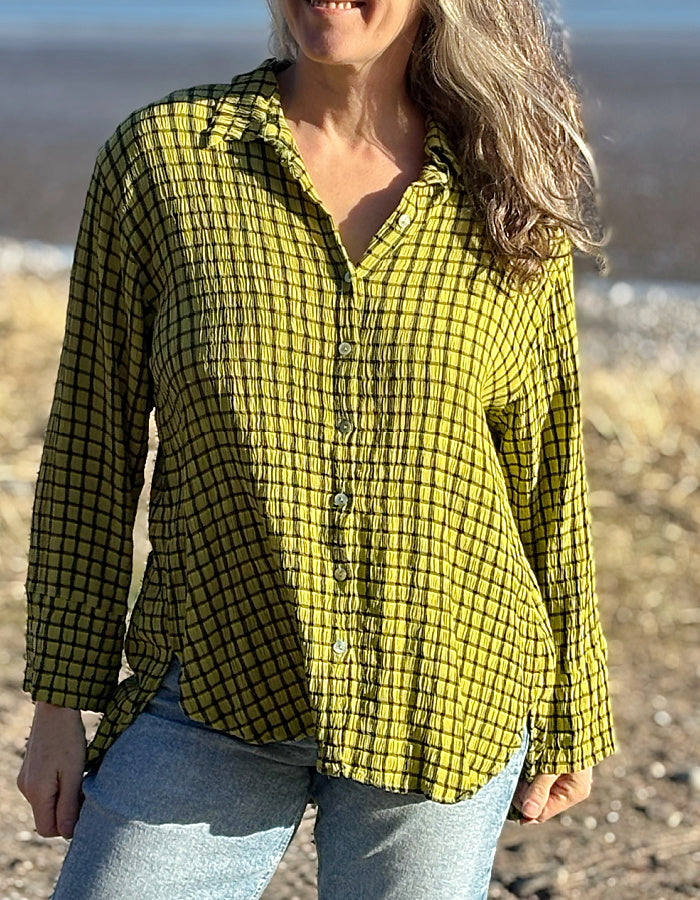 ochre green viscose swing shirt with black check print. box pleat at the back