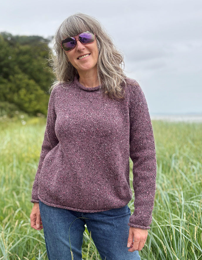 woman wearing donegal tweed dark mauve pink roll neck sweater