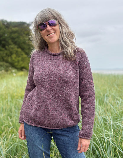woman wearing donegal tweed dark mauve pink roll neck sweater