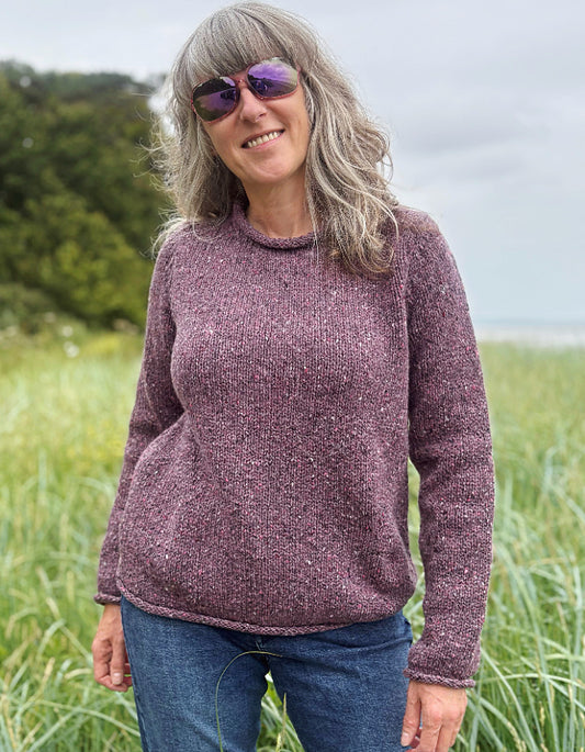 woman wearing donegal tweed dark mauve pink roll neck sweater