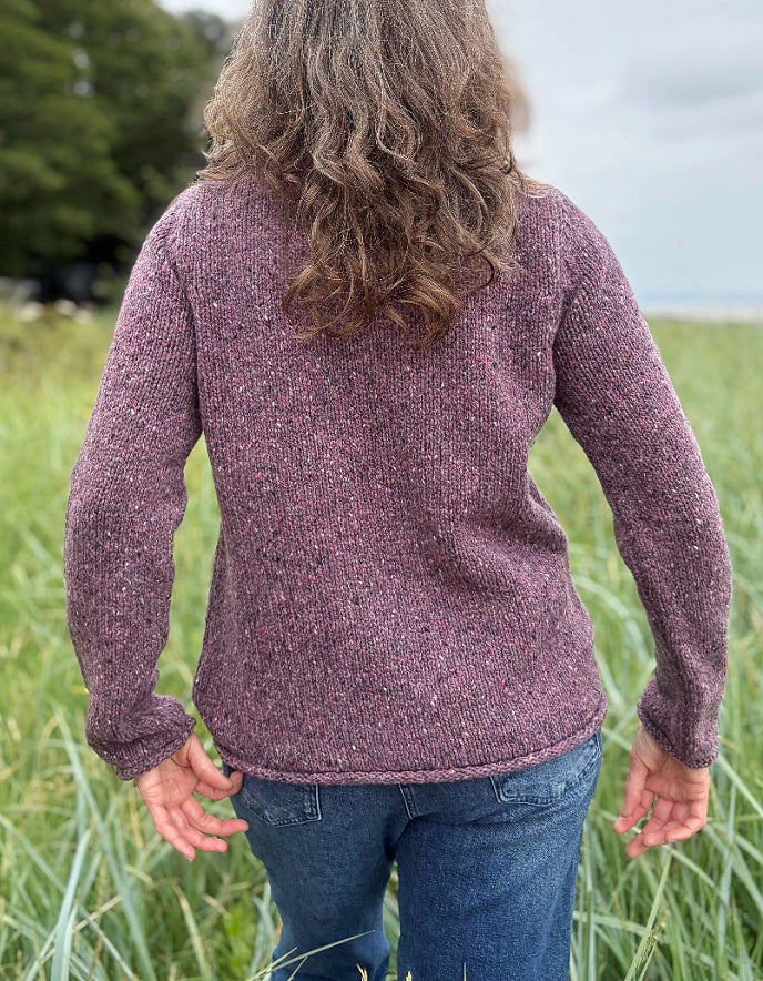 woman wearing donegal tweed dark mauve pink roll neck sweater