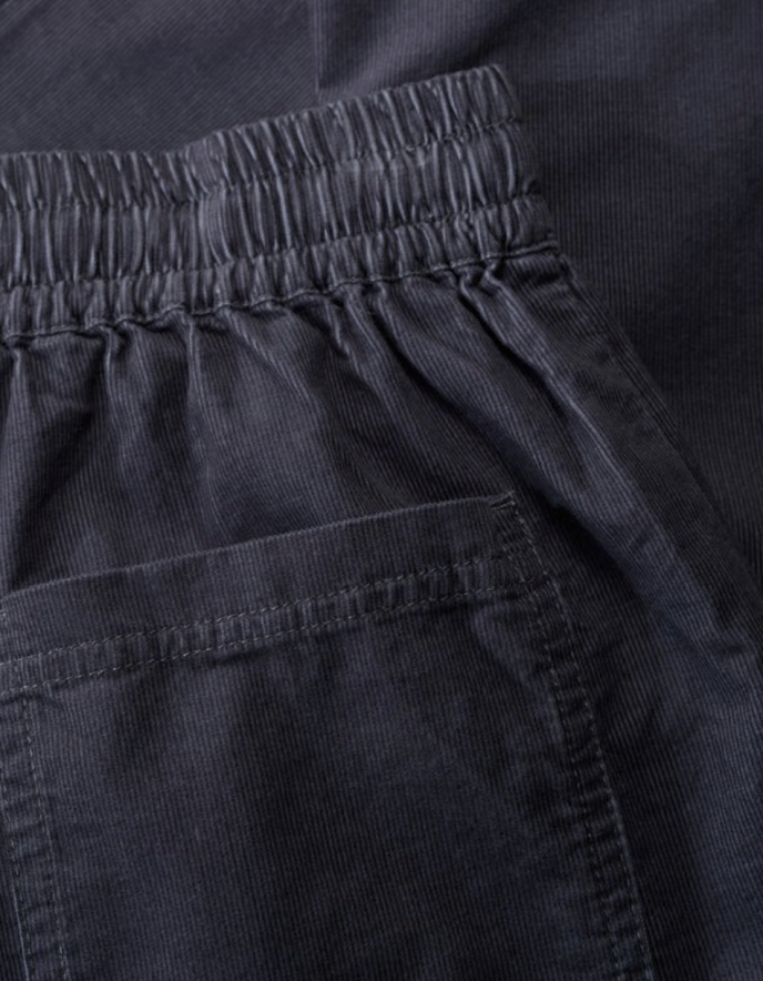 Close-up of dark grey pants with an elastic waistband