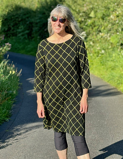 black shift dress with 3/4 length sleeve and lime green diamond design