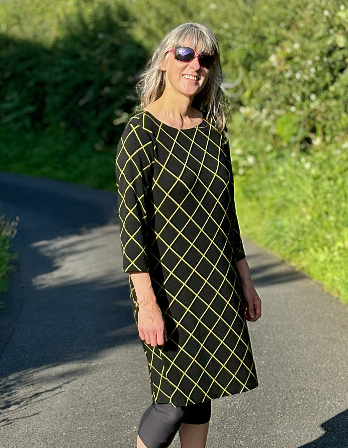 black shift dress with 3/4 length sleeve and lime green diamond design