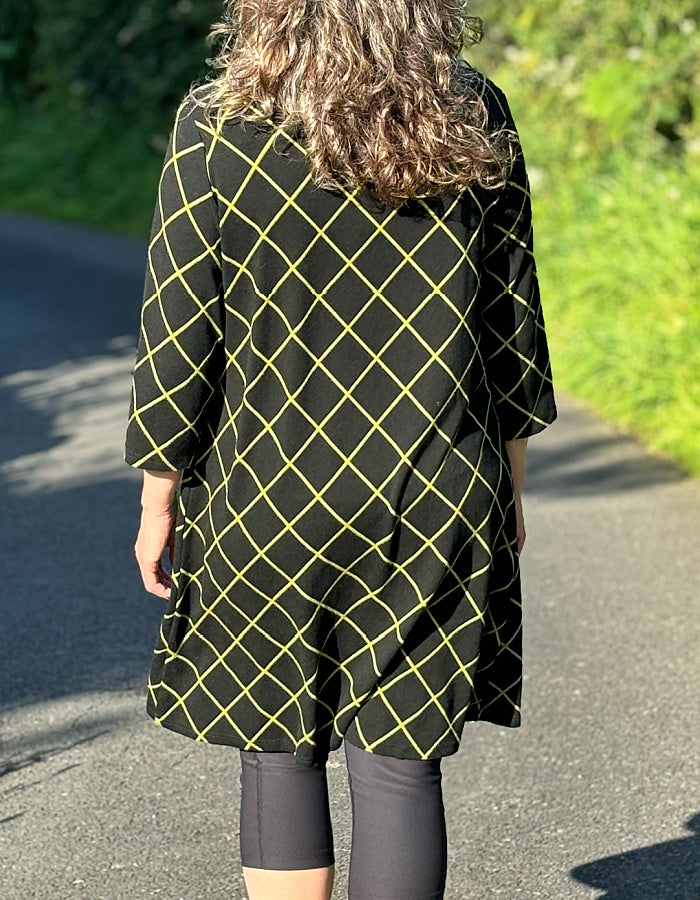 black shift dress with 3/4 length sleeve and lime green diamond design