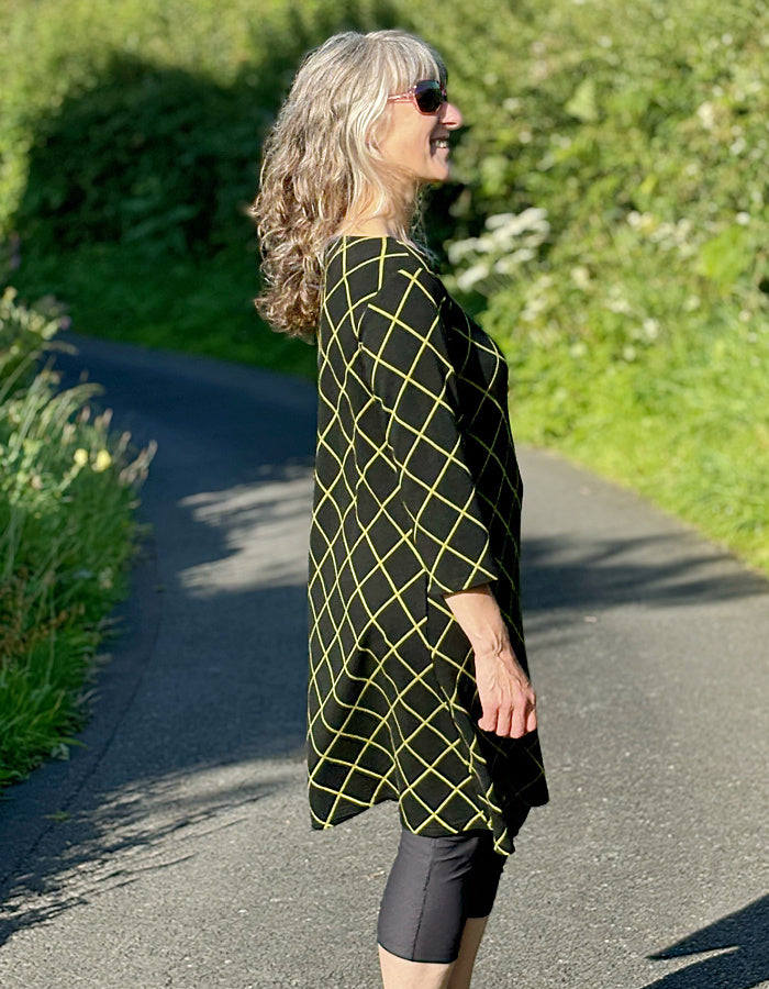 black shift dress with 3/4 length sleeve and lime green diamond design